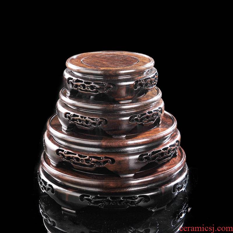 Wooden circular classical vase holder base solid wood carve patterns or designs on woodwork black twigs rounded root carving craft flowerpot base