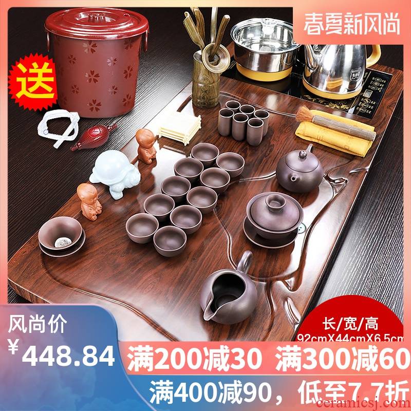 The teapot tea tray was domestic tea set automatic purple sand pottery and porcelain of a complete set of kung fu solid wood tea tea cups