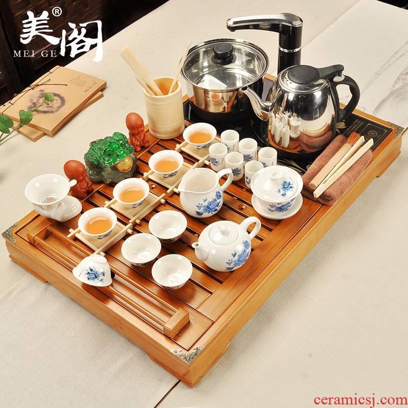 The cabinet of household ceramic teapot teacup kung fu tea set solid wood tea tray was four unity tea tea set electric heating furnace