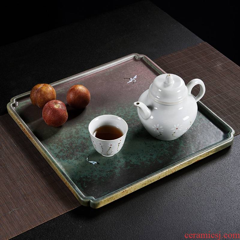 Old ceramic up saucer at the grid plate of Japanese zen tea tray was restoring ancient ways of household dry plate bearing tea pot heart plate