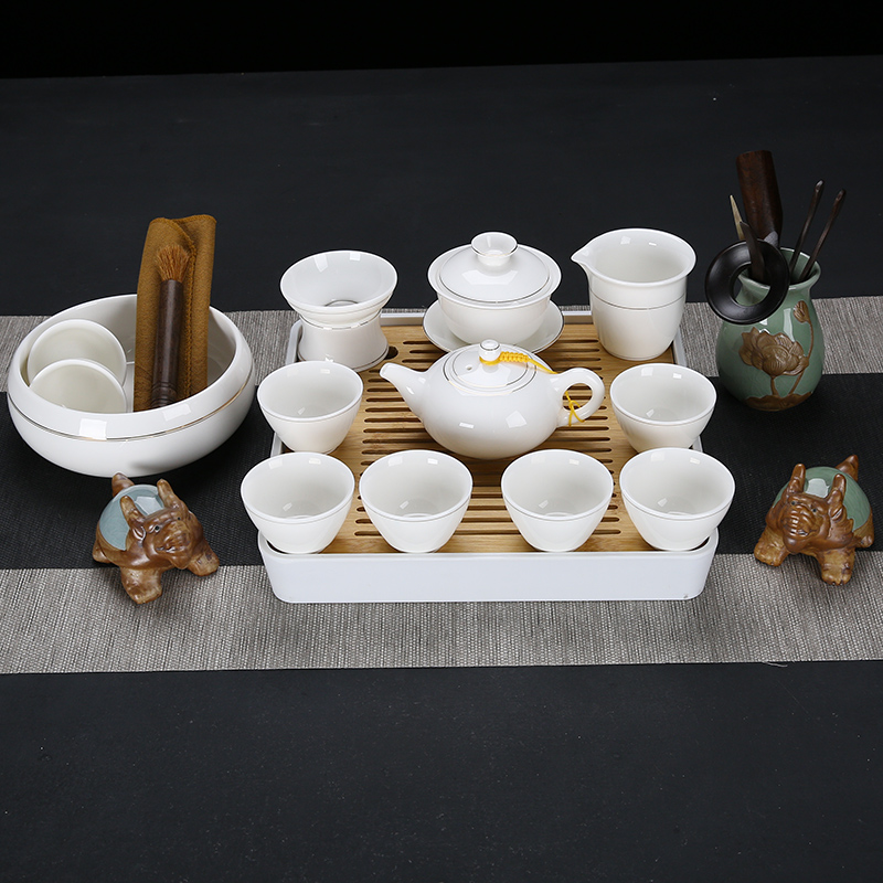 Dehua white porcelain kung fu tea set suit household suet jade cups of a complete set of the tea pot lid to use simple wooden side