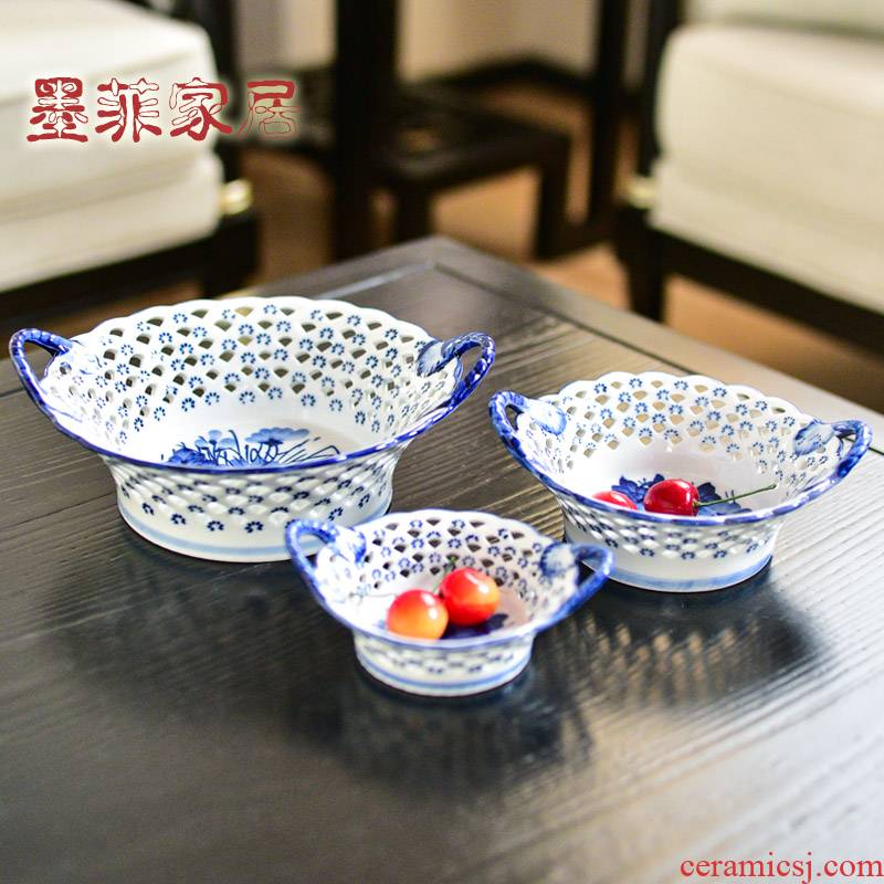 The New Chinese blue and white porcelain of jingdezhen ceramic hollow out fruit bowl sitting room household dry fruit tray table furnishing articles to receive dish